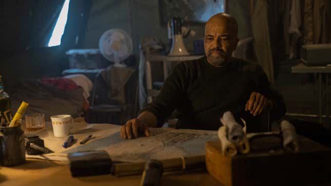 Isaac looks at a map on his desk.